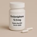 White plastic pill bottle labeled Enclomiphene, 12.5 mg, Batch No.004, dated 19-07-2025, with two white capsules beside it, set on a beige background