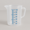 Clear measuring cup with blue measurement markings on a gray background