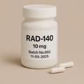 A photograph of a white plastic pill bottle labeled "RAD-140, 10 mg, Batch No.002, 11-05-2025." The bottle stands on a beige surface with two white capsules placed neatly in front. Minimalist beige background and bold black typography emphasize the clean, professional pharmaceutical design